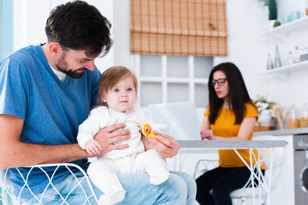 A claim to establish paternity - dad holding child kitchen